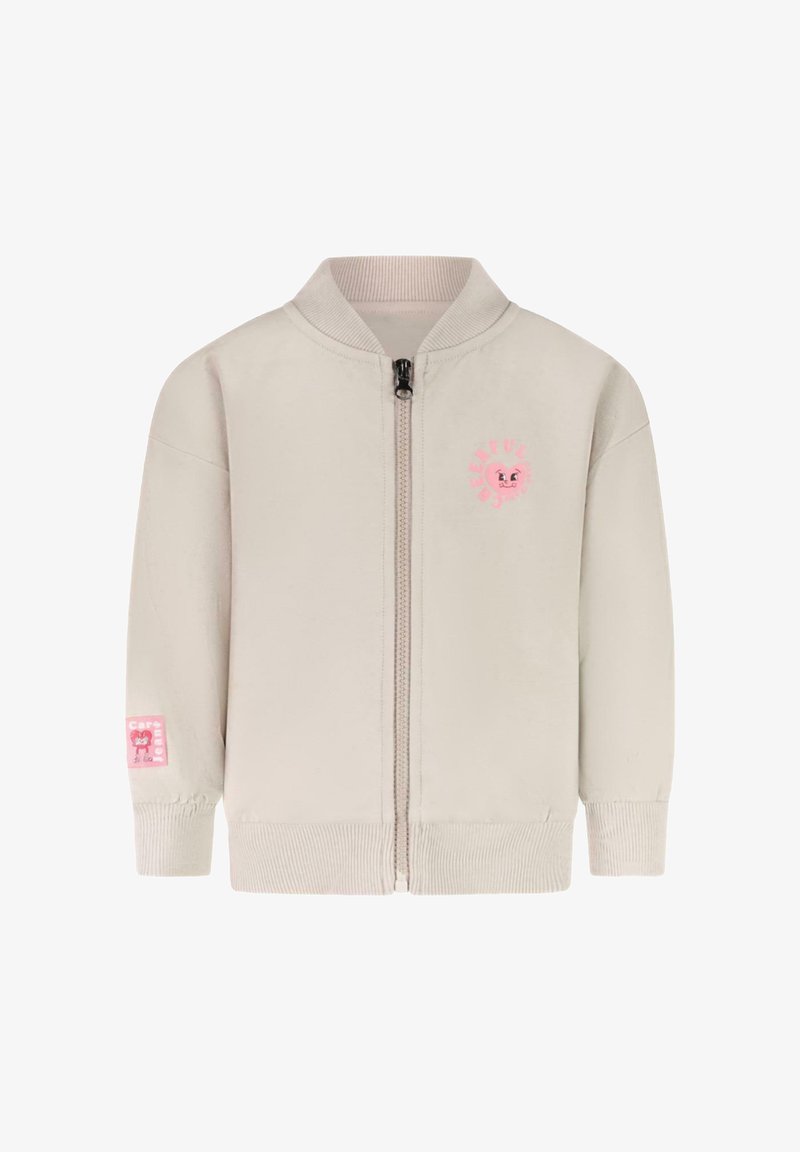 Lichtbeige ritsjack met een geribde kraag en manchetten. Heeft een roze glimlachend gezichtlogo op de borst en een roze label op de mouw.