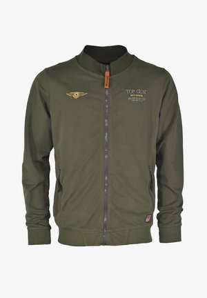 Olivgrüner Bomberjacke mit Reißverschluss, gerippten Bündchen und Saum. Mit gesticktem "Top Gun"-Logo und geflügeltem Abzeichen auf der Brust.