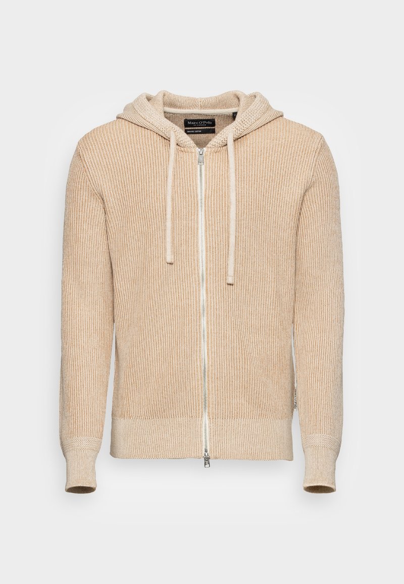 Beige ribbad hoodie med en full dragkedja, snörning i huvan och texturerat stickat mönster. Fitted ärmar och midja ger en snug passform.