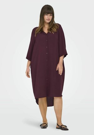 Burgundy button-up dress with a relaxed fit, 3/4 sleeves, and a longer back hem. Made from lightweight fabric, featuring a smooth texture.