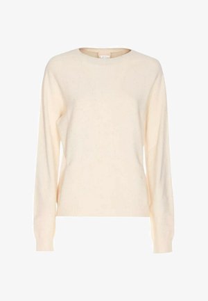 Pull couleur crème en maille douce, avec un col rond et des manches longues, présentant une texture subtile et des détails mouchetés.