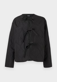 Μαύρο μπουφάν με καπιτονέ ραφές, μακριά μανίκια και τρία δεμένα φιογκάκια μπροστά, με κυματιστό σχέδιο ραφής και στρογγυλή λαιμόκοψη.