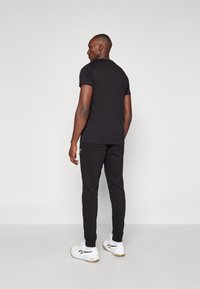 Björn Borg ESSENTIAL PANTS - Treniņtērpa apakšdaļas - black beauty