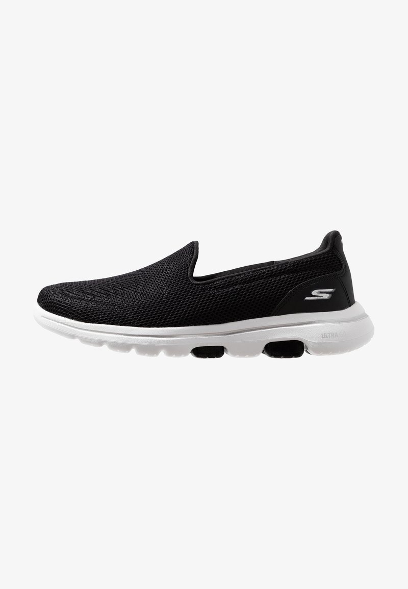 Baskets noires à enfiler avec dessus en mesh respirant et semelle blanche amortissante avec capsules d'air noires, logo latéral près du talon.