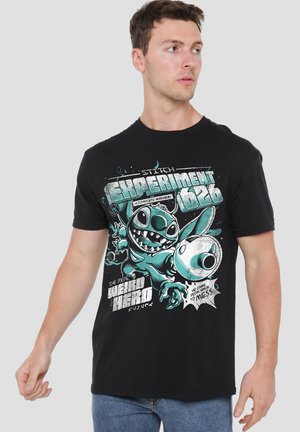 Black cotton t-shirt featuring colorful graphic of Stitch, a blue character, with bold text and comic-style elements on the front.