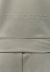 Light gray sweatshirt with a smooth texture. Features embossed text: "EARTH'S WATER BREAKDOWN 97.5% SALINE 2.5% FRESHWATER" in beige.