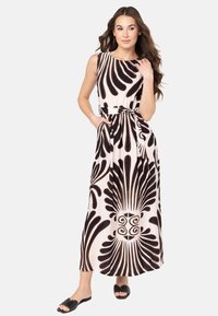 Maxi-Kleid in Creme mit auffälligen schwarzen Blumenmustern. Ärmelloses Design, Taillengürtel, Seitentaschen, fließender Stoff und entspannte Silhouette.