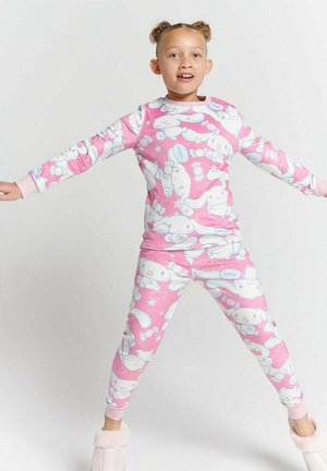 Rosa Schlafanzug-Set mit langen Ärmeln und Leggings, versehen mit Cartoon-Hasen und Blumen. Weicher Stoff mit kontrastierenden Bündchen und Bund.