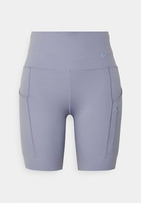 Pantaloni sportivi larghi in lavanda a vita alta con tasche laterali, una delle quali con zip, realizzati in tessuto elastico e morbido.