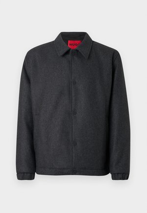 Giacca grigio scuro in misto lana, con chiusura frontale a bottoni, colletto classico e polsini elastici per una vestibilità aderente delle maniche.