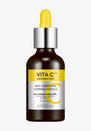 Ruskea lasinen pipettipullo keltaisella kannella, jossa etiketti Vita C Plus askorbiinihappo täsmäkorjaava ja kiinteyttävä ampulli, 30 ml, valmistaja Missha.