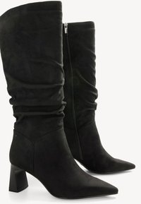 Black knee-high boots made of suede, featuring a pointed toe, block heel, and a side zipper with gathered detailing at the top.