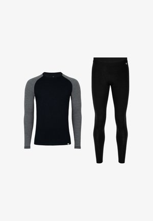 Le jeu de couches de base comprend un haut noir à manches longues avec des manches raglan grises et un legging noir. Le matériau semble lisse et extensible.