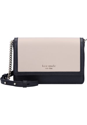 Two-tone beige and black leather crossbody bag with silver chain strap and "kate spade new york" logo on front flap.