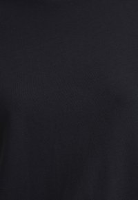 Dark navy blue t-shirt made of soft, smooth cotton fabric. Features a simple, seamless design with no visible patterns or hardware.