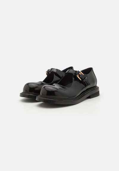 Musthave musta lakk sise võitejunnivedib mustat need on toapakkumasülemärk läikivgolduga kumsikehiga. Mustplatesees jalad, ümarad otsad, madal põhjala vast TÜ-kand ja kuldne  конструкционалζεται on għaj feta. 