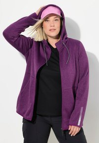 Lila Kapuzenjacke mit strukturiertem Finish, ausgestattet mit einem durchgehenden Reißverschluss, Kordelzügen und reflektierenden Details an den Ärmeln.