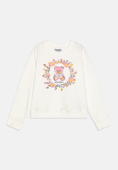 Sudadera de color crema con un gráfico central de un oso rodeado de diseños florales. Puños y dobladillo acanalados con un ajuste relajado.