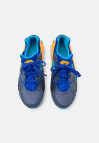 Sport shoes with a blue, gray, and orange color palette, featuring a smooth synthetic upper, lace closure, padded collar, and textured sole.
