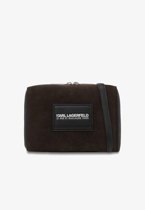 Temno rjava pravokotna torbica iz antilop usnja čez ramo s črnim usnjenim trakom in sprednjim logotipom v obliki obliža z napisom "KARL LAGERFELD 21 RUE ST-GUILLAUME PARIS."