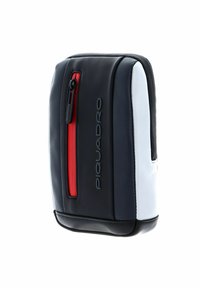 Borsa in pelle bianca e nera con dettaglio della zip rossa, forma rettangolare, superficie texturizzata, con il logo "Piquadro" ben visibile di lato.