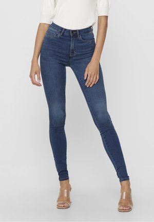 Jeans skinny a vita alta blu realizzati in denim, con una texture liscia, design classico a cinque tasche e chiusura con zip e bottone.