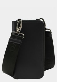 Black leather crossbody bag with a textured surface, zip closure, and adjustable fabric strap, featuring silver hardware and embossed logo detail.