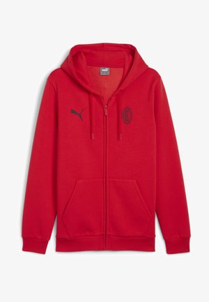 Punane lukuga kapuutsiga sviiter, mis on valmistatud pehmest kangast. Omab kapuutsi, kängurupunkte, musta Puma logo ja välja õmmeldud AC Milani embleemi rinnal.