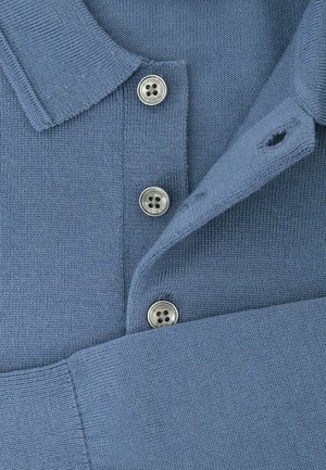 Niebieska dzianinowa koszulka polo z klasycznym kołnierzykiem, trzema srebrnymi guzikami oraz gładką fakturą, z małą dziurką w pobliżu kołnierzyka.