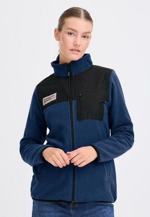 Fleecetröja i marinblått med en svart överdel. Har en dragkedjeförsedd framficka, hög krage och kontrasterande sömmar.