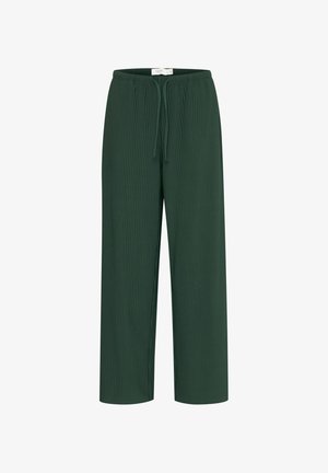 Gröna ribbade byxor med rak ben-design, utrustade med ett elastiskt midjeband med dragsnöre för justerbar passform. Texturerat tyg.