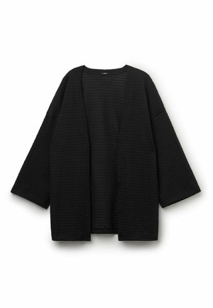 Cardigan noir texturé à ouverture devant, manches longues larges, coupe ample, sans boutons ni fermetures visibles, présenté sur fond blanc.