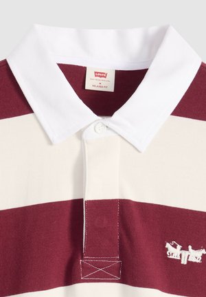 Polo shirt with wide horizontal burgundy and white stripes, white collar, button placket, and small white embroidered logo on chest.