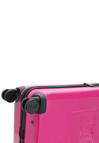 Pink hard-shell suitcase with black wheels and zippers. Features embossed LEGO logo and smooth, glossy texture. Compact design for travel.