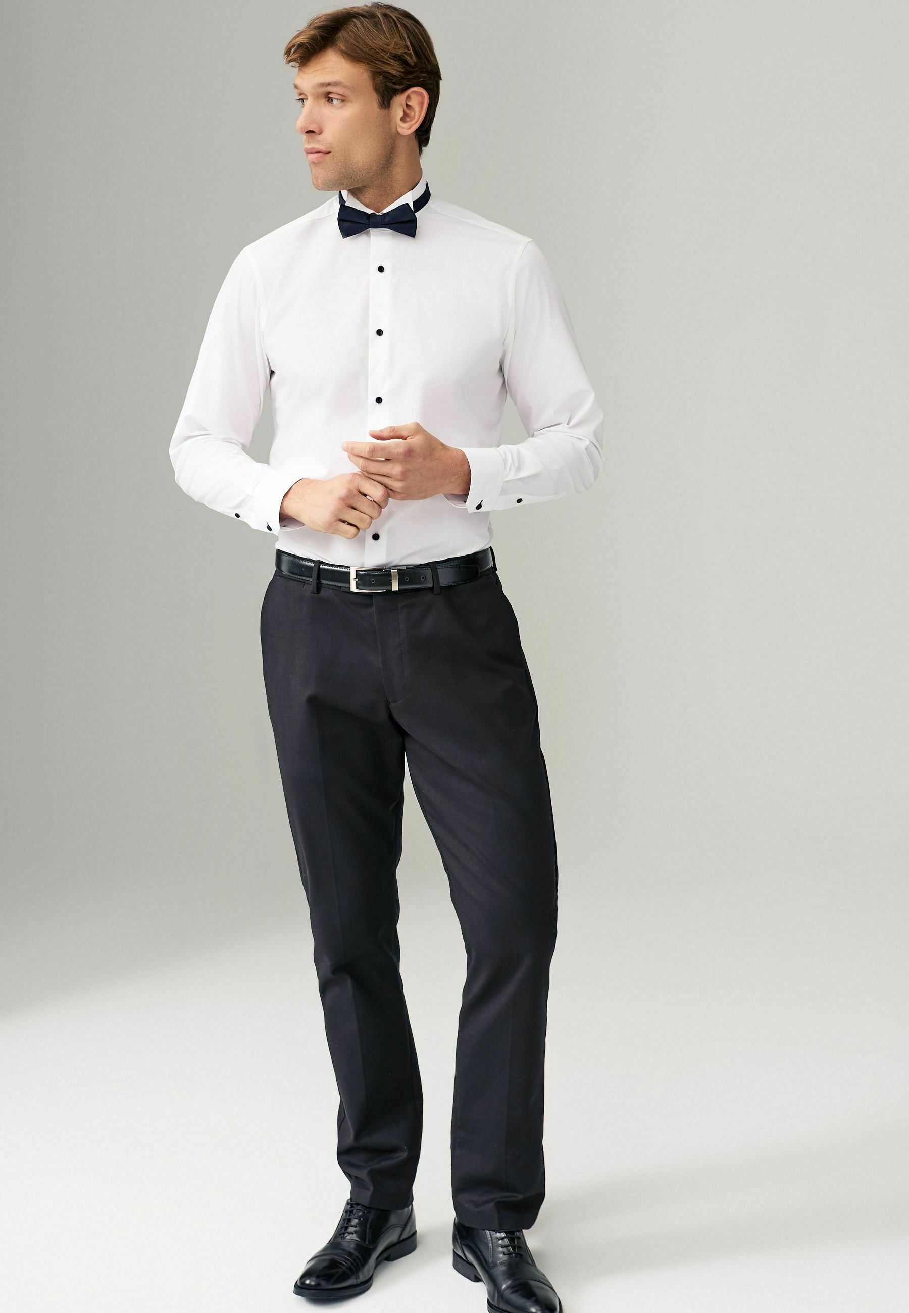white shirt and white bow tie