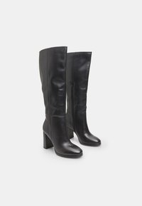 Cizme negre din piele, până la genunchi, cu o textură netedă, toc pătrats și fermoare laterale. Prezintă un design ajustat și vârf rotund.