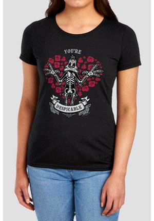 Woman wearing black T-shirt with skeleton cartoon duck in front of red roses and text "You're Despicable" on the chest.