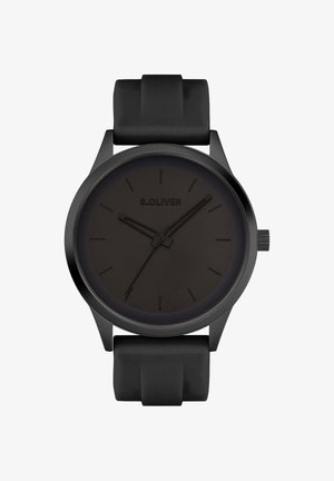 Montre noire avec une finition mate, boîtier rond et bracelet en silicone noir. Dispose d'index et d'aiguilles minimalistes sur un cadran sombre.