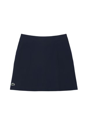 Gonna atletica blu navy realizzata in tessuto morbido con una forma svasata. Presenta un orlo cucito e un piccolo logo di coccodrillo verde in basso a sinistra.