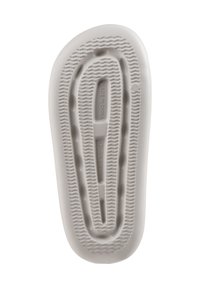 White rubber shoe sole with textured patterns and ridges. Features an oval shape with a central groove and "MADE IN CHINA" imprint.