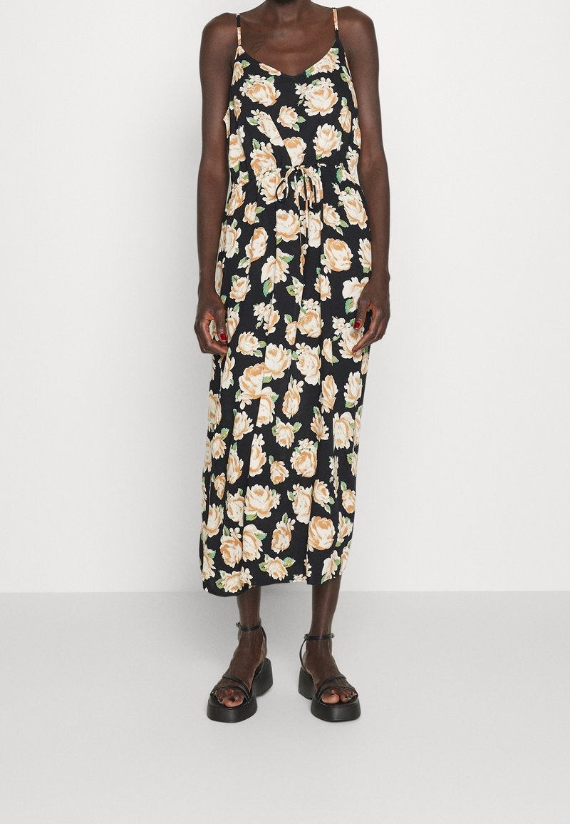 Květinové midi šaty s černým pozadím, ozdobené světlými oranžovými růžemi, s nastavitelnými ramínky a stahovacími šňůrkami v pase. Vyrobené z měkké tkaniny.