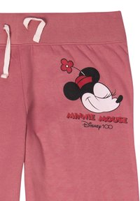 Pantaloni della tuta rosa con vita regolabile, presentano una grafica nera di Minnie Mouse e dettagli rossi, tra cui un fiore e il testo: "MINNIE MOUSE Disney 100."