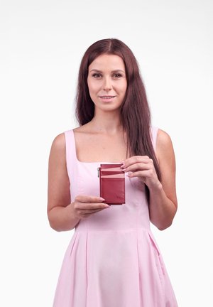 Red leather wallet with a zip pocket and card slots. Features a smooth texture and minimal design. Stamped logo detail on the front.