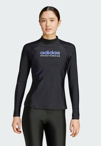 Black long-sleeve rash guard made of smooth, stretchable fabric, featuring a crew neck and a contrasting light blue Adidas logo on the chest.