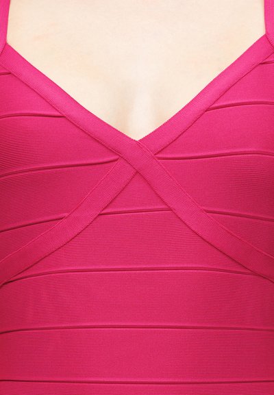 Κοντινή λήψη ροζ υφασμάτινου φορέματος με διασταυρούμενους ιμάντες στο στήθος και ντεκολτέ σε σχήμα V.