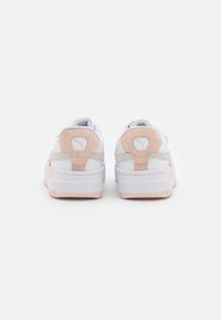 Sneaker bianchi e pesca con dettagli in suede e mesh. Presentano un colletto imbottito, una linguetta sul tallone con il marchio e suole in gomma.