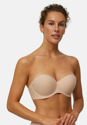 Sujetador sin tirantes color nude con tejido suave, copas moldeadas y diseño sin costuras. Ligero y versátil para diversos conjuntos.