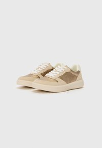 Light brown sneakers with a textured suede upper, white laces, and a cream rubber sole. Smooth accents complement the design.
