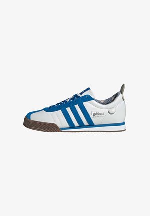 Baskets Adidas Samba blanches et bleues avec semelle en gomme, trois bandes bleues et doublure intérieure à carreaux, vues de profil.