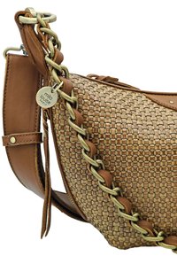Sac à main tissé de couleur beige avec une forme structurée, doté d'une bandoulière en cuir marron et d'un détail en chaîne tressée dorée. Comprend une étiquette de marque.